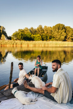 Friends And Family Enjoy Lake Day With Dogs