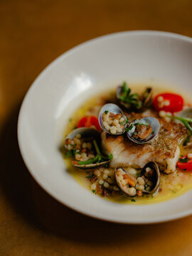 White fish with mussels and cous cous