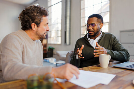 Business professionals having a conversation during workday