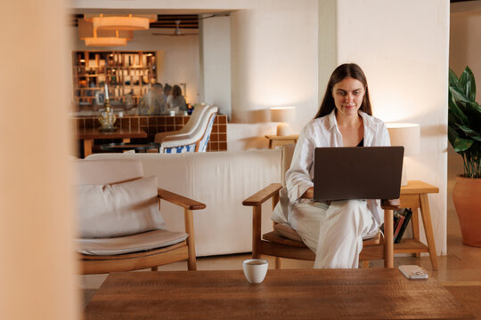 Woman on Laptop  Cozy Lounge