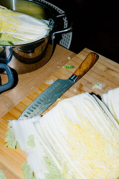 Flash-lit close-up of a home kitchen workspace with chopped cabbage