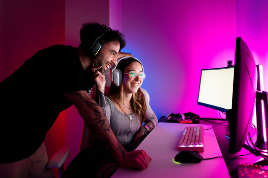 Happy Gaming Couple at Colorful Setup