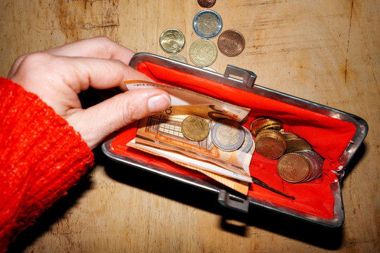 Money, Euro. Hand Reaching Cash Inside wallet