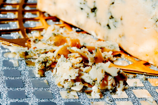 a close-up of blue cheese crumbs and a wedge