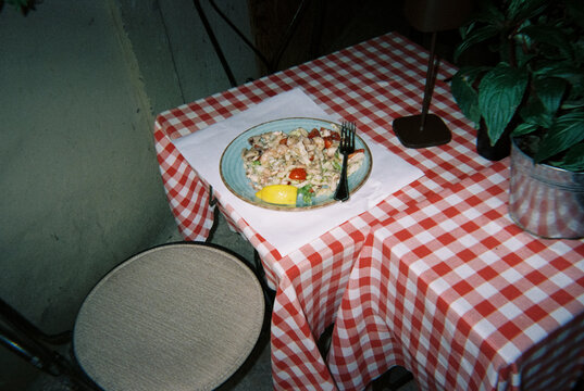 frutti di mare pasta on a checkered restaurant table, 35mm film