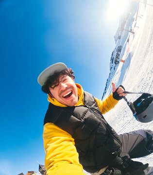 Man Taking Action Selfie While Snowboarding
