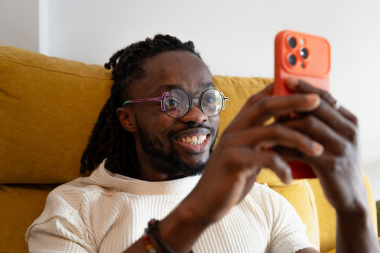 Man with dreadlocks using smartphone