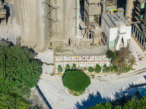 Aerial View of Dust-Covered Cement Factory and Industrial Buildi