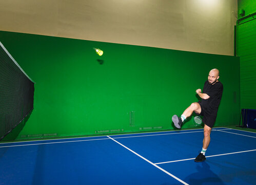 Funny Playing Badminton Indoors With Shuttlecock at Sports Facility