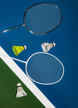 Badminton Rackets and Shuttles on Blue and Green Court Surface