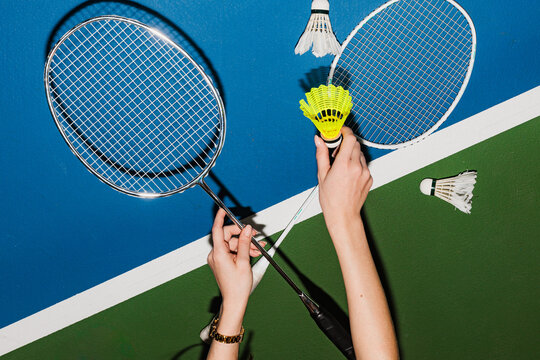 Players Prepare for Badminton Game in Indoor Court