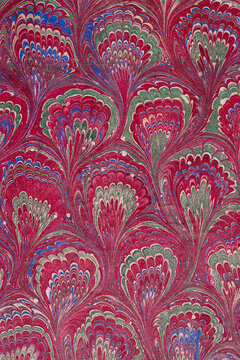 Colorful vintage Paper With Swirls and Patterns on a Red Background