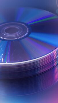 Colorful reflection of stacked CDs creating an abstract art piece in a modern context for music and technology enthusiasts.