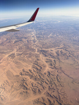 View to desert and airplane wing
