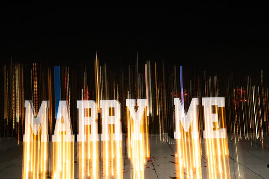 Marry Me Sign with Lights at Night
