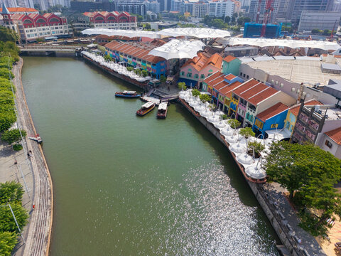 Rows of colorful buildings and sunshades along a riverside waterfront