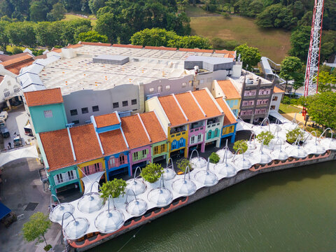 Rows of colorful buildings and sunshades along a riverside waterfront