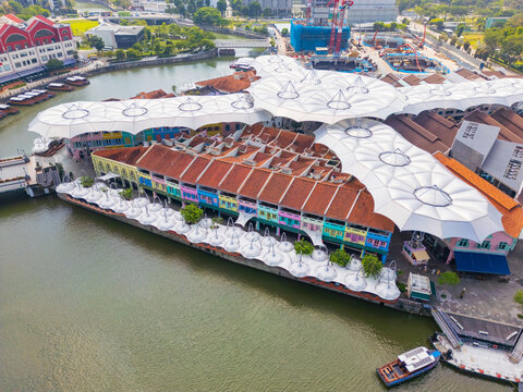 Rows of colorful buildings and sunshades along a riverside waterfront