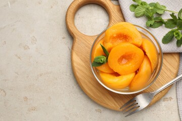 Pickled peaches and mint leaves in bowl on light grey table, flat lay. Space for text © New Africa