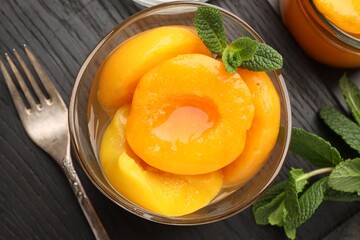 Pickled peaches and mint leaves on table, flat lay © New Africa