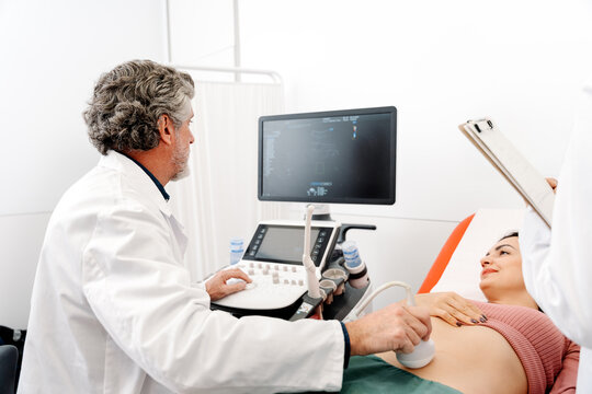 Medical team performing abdominal ultrasound on patient