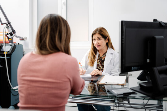 Doctor discussing medical information with patient in consultation