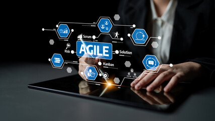 Fototapeta premium A close-up view of a business professional interacting with a tablet, featuring agile project management graphics, illustrating concepts like scrum and kanban in a modern workspace. Tessel