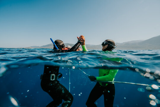 Freediving coach and student celebrating succesful dive
