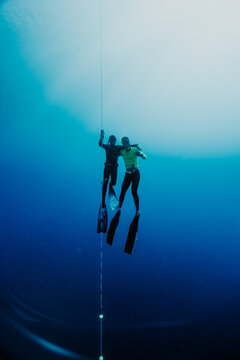 Freediving partners ascending together along training line