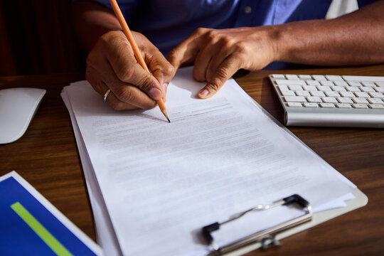 Anonymous man signing the document