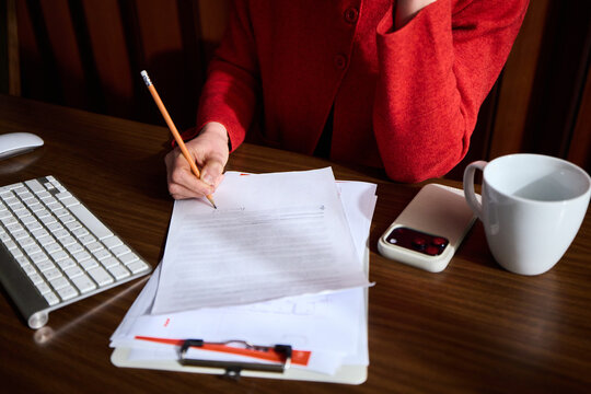 Anonymous woman signing the document