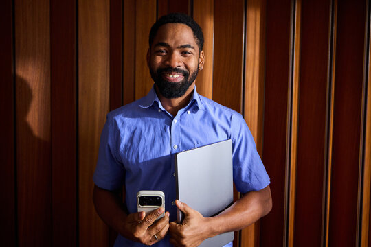 Happy man holding technical devices