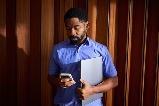 Busy man holding technical devices