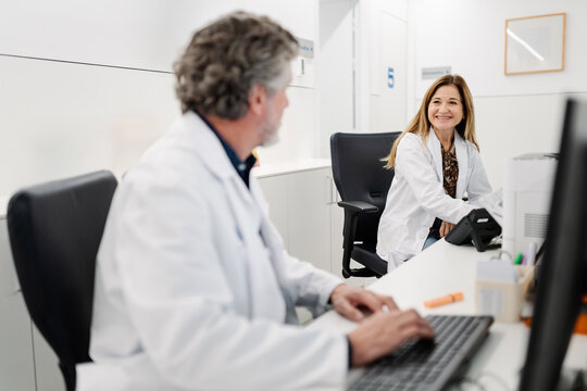 Doctors collaborating and smiling in a modern clinic office