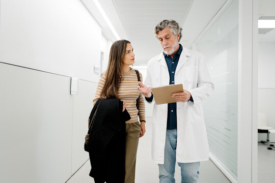 Doctor discussing medical information with patient in hospital