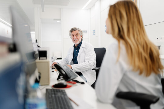 Doctors collaborating and smiling in a modern clinic office