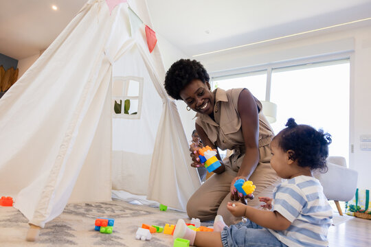 Parent playing with toddler in cozy playroom