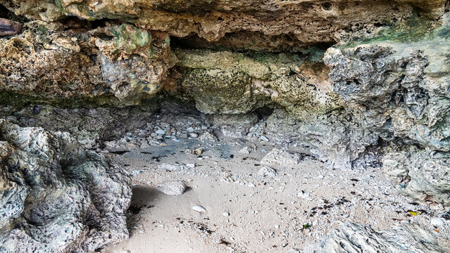 Volcanic island and grotto; grot caves in calcareous rocks and calcareous white sediment. Spice Islands and the Banda Sea