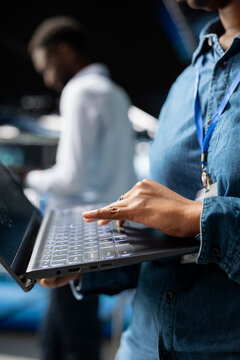 Close up of female supervisor overseeing staff doing AI automatization, machine learning for servers infrastructure. Data center specialist managing operations with artificial intelligence.