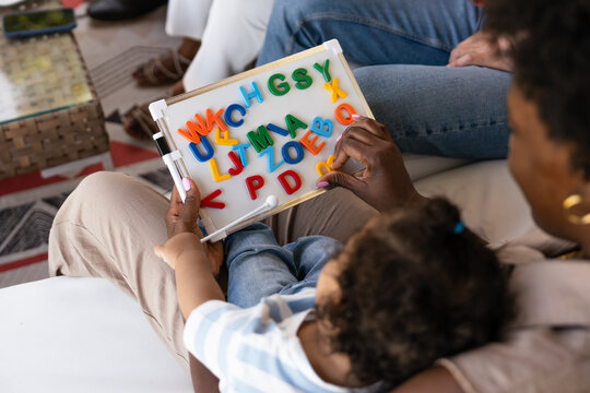 Parent and child learning with colorful alphabet board
