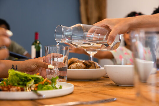 Pouring water at a family meal gathering