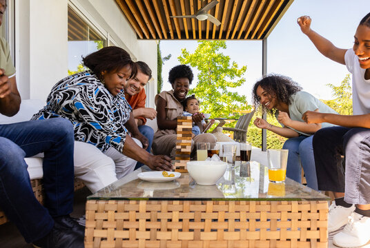 Family and friends enjoying board game outdoors