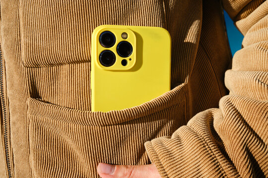 Yellow Smartphone in Jacket Pocket Close-Up