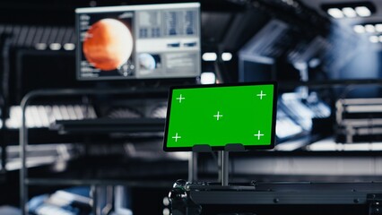 Fototapeta premium Chroma key tablet in orbital station surrounded by high tech gear tracking telemetry software. Isolated screen device enabling real time mission control and spacecraft status updates