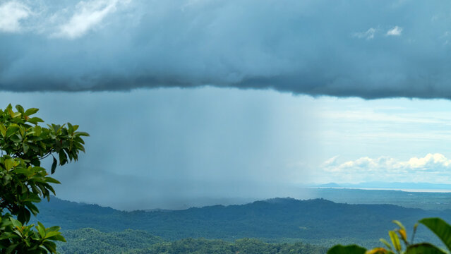 Monsoon season in the tropics. Thunderstorm, a tropical downpour over the equatorial rain forest of Borneo Island. Malaysia, city