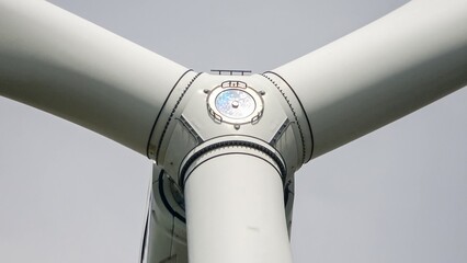 Wind turbine blades connecting to hub generating clean energy © Michael