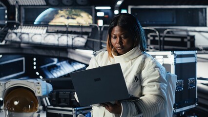 Fototapeta premium Astronaut checks orbital navigation data in cockpit after completing planet surface expedition. Cosmonaut running telemetry software, updating flight log to return home