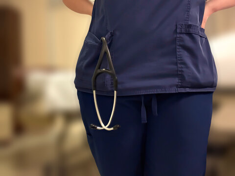 Faceless Nurse Standing at Hospital Bedside with Stethoscope in Scrubs Pocket Healthcare Professional Concept