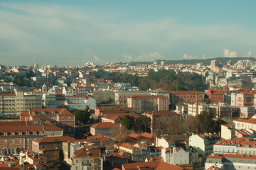 Obraz premium Beautiful red roof tops of portuguese buildings in lisbon on a sunny day with blue sky