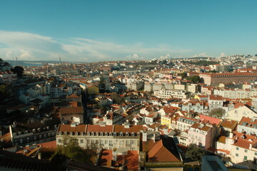 Obraz premium Beautiful red roof tops of portuguese buildings in lisbon on a sunny day with blue sky